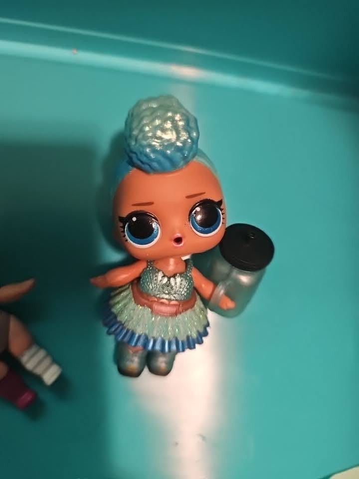 Blue green doll with bottle